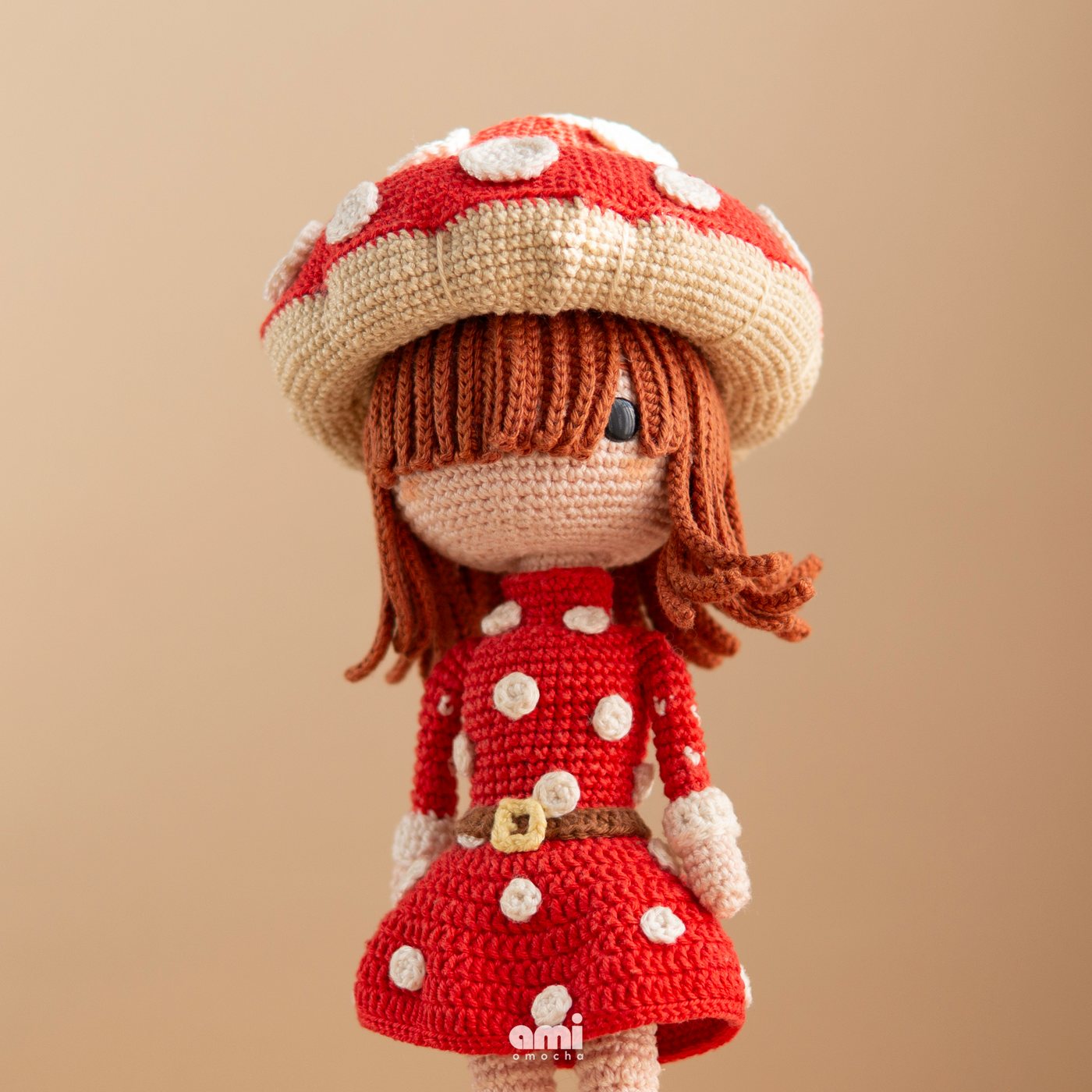 Crocheted mushroom girl doll in a red polka dot dress, designed by Aneta